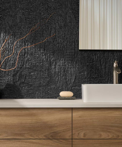 Bathroom vanity with wooden cabinets, white countertop, and black textured wall.