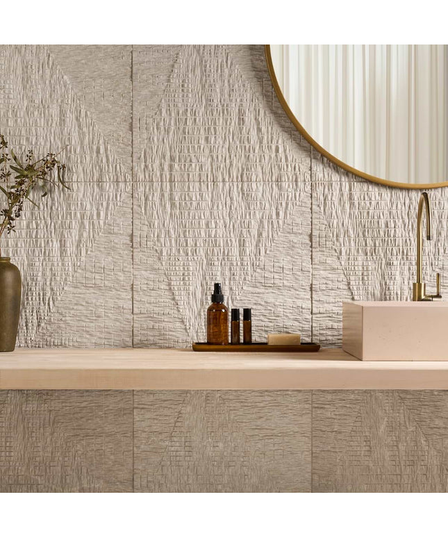 Bathroom vanity with textured tiles, a mirror, and decorative items.