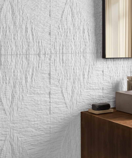 Bathroom with textured white wall tiles and wooden vanity.