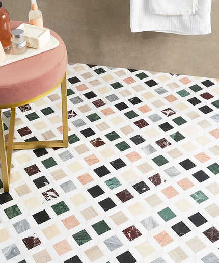 Bathroom with a patterned floor, pink stool, and towel.