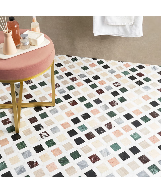 Bathroom with a patterned floor, pink stool, and towel.