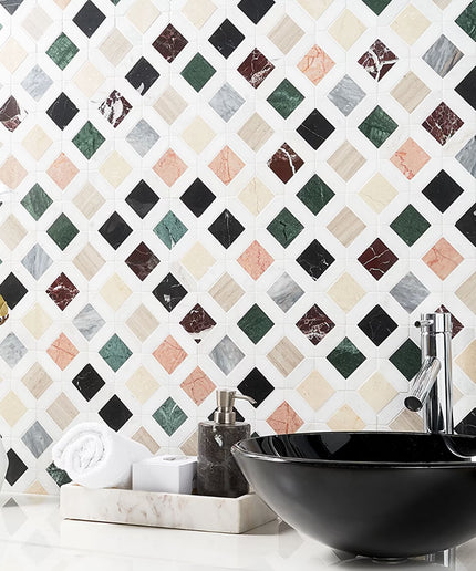 Bathroom setting with a black sink against a patterned tile wall.