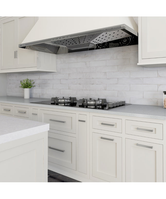 Modern kitchen with white cabinets, gray countertop, and stainless steel range hood.