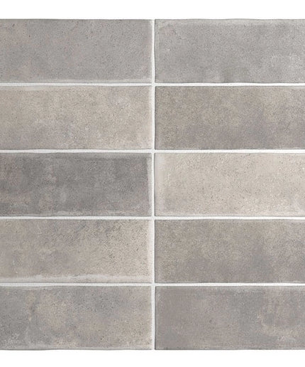 Pattern of gray tiles with varying shades on a white background