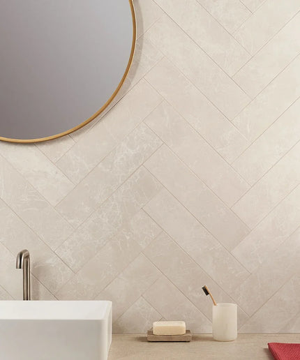 Crema Volterra 4x16 semi-polished tile wall in modern bathroom with herringbone pattern