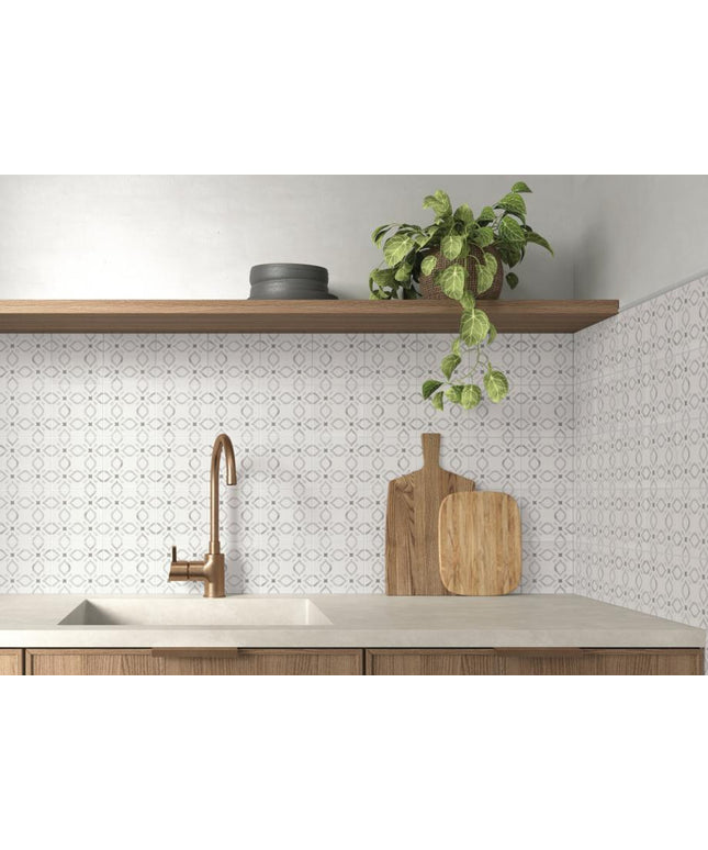 Modern kitchen with a sink, wooden cutting board, and plant on a shelf.