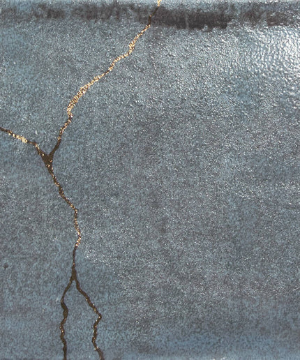 Textured gray surface with a crack running through it