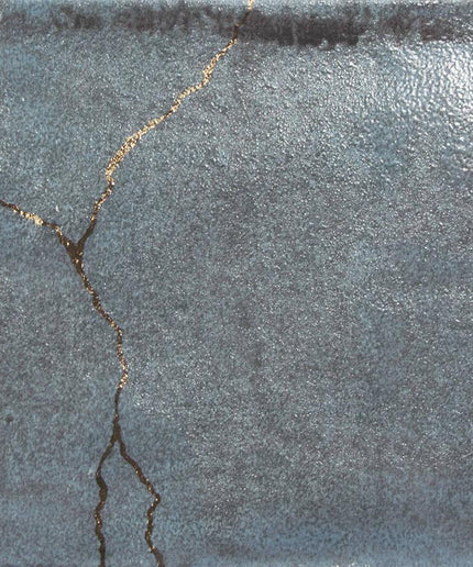 Textured gray surface with a crack running through it