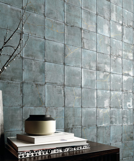 Decorative teal tiles with a vase and books on a table