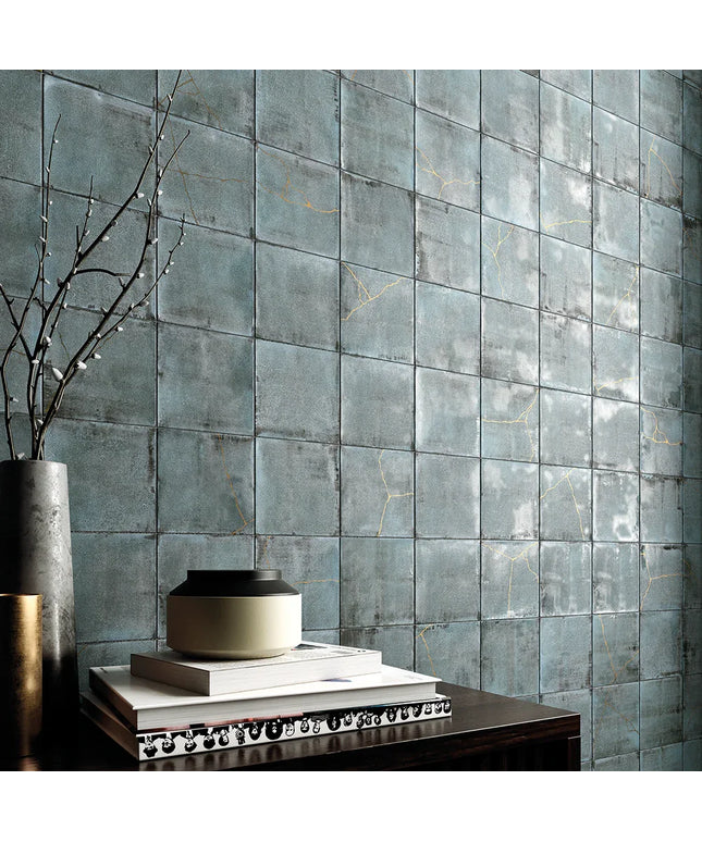 Decorative wall with blue tiles and a vase on a table