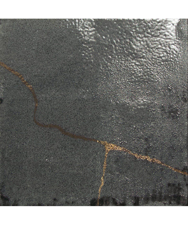 Close-up of a textured dark surface with a gold line