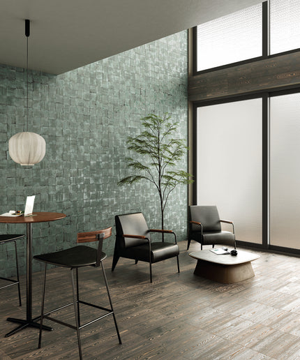 Modern interior with green textured wall, wooden floor, and furniture.