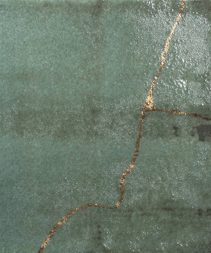 Green stone with a gold vein running through it