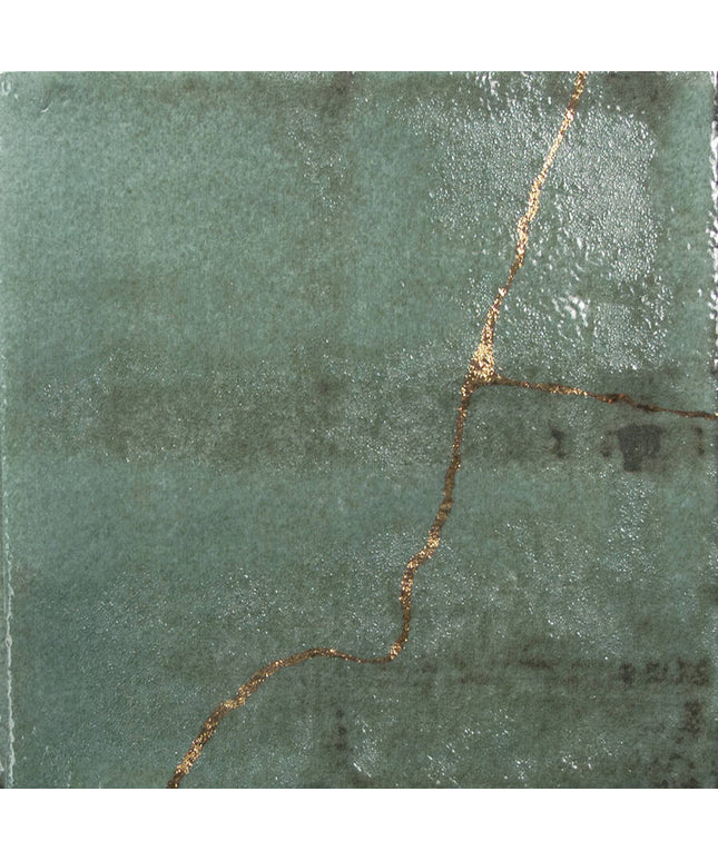 Green stone with a gold vein running through it