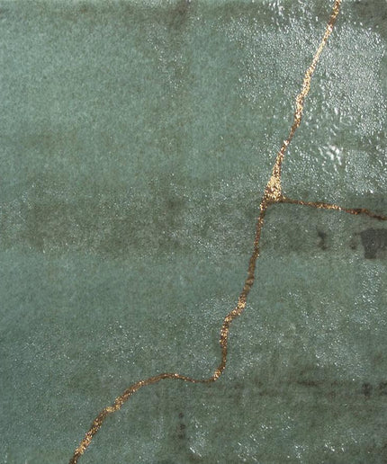 Green stone surface with a gold line running through it