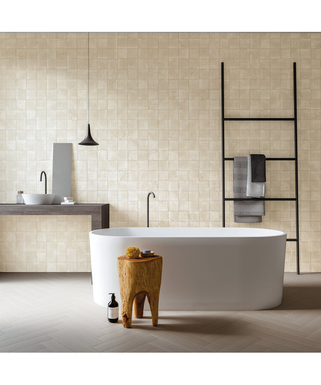 Modern bathroom with a freestanding bathtub, wooden stool, and towel rack.