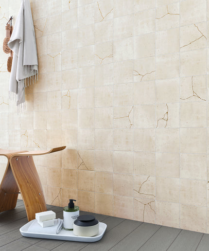 Beige tiles with a wooden stool and bathroom items on a tray