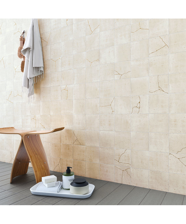 Beige tiles with a wooden stool and bathroom items on a tray
