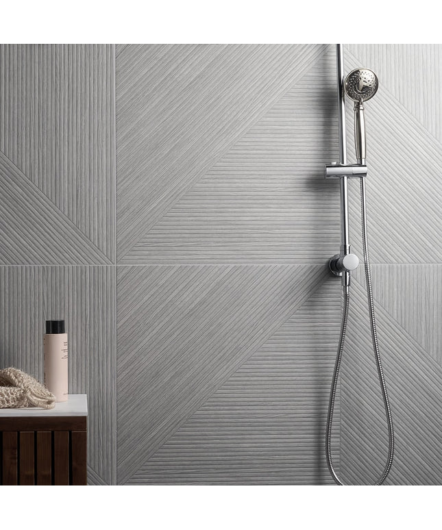 Shower setup with tiled wall and handheld shower head
