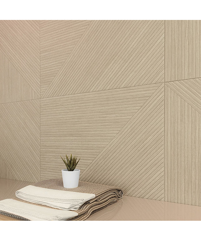 Beige geometric-patterned wall tiles with a plant and folded blanket on a surface.