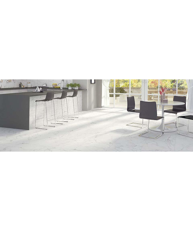 Modern kitchen and dining area with bar stools and a table.