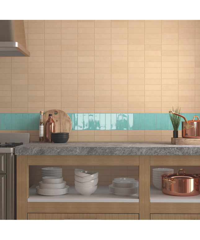 Modern kitchen backsplash with beige subway tiles and aqua accent strip behind countertop.