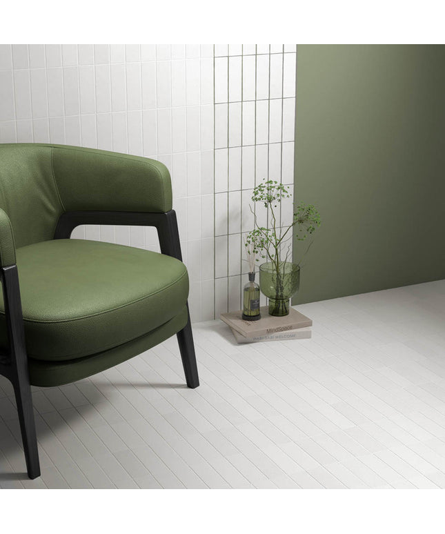 Modern room with matte white floor tiles, green accent wall, and green chair
