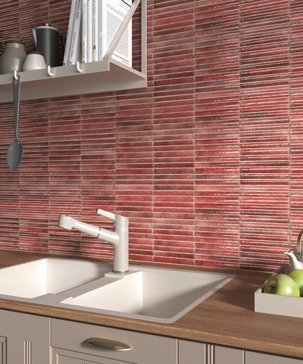 Kitchen with red tiled backsplash, white sink, and wooden countertop.