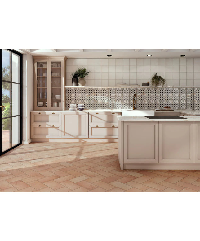 Modern kitchen with light wood cabinets, white tiled walls, and a checkered floor.