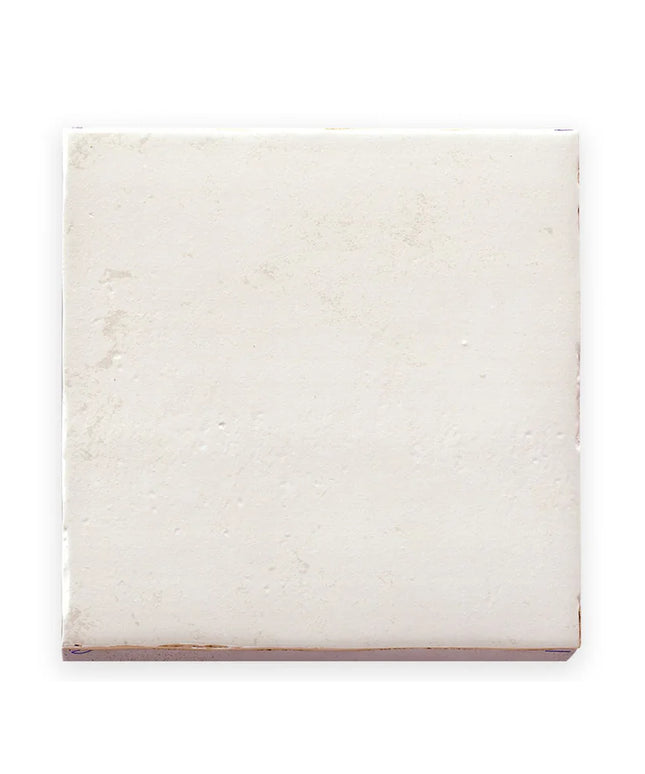 White marble tile with subtle veining on a white background