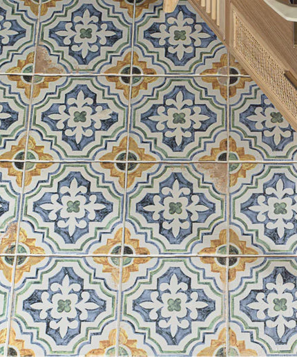 Patterned tiles on a floor with a wooden cabinet in the corner.