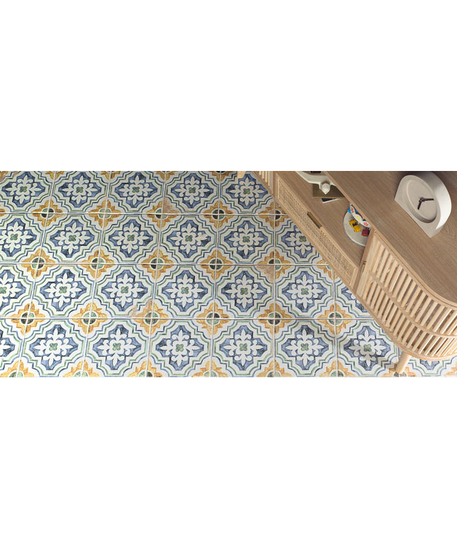 Patterned tiles on a floor with a wooden cabinet in the corner.