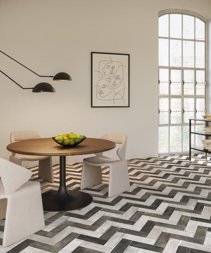 Modern dining room with a round wooden table, white chairs, and abstract art on the wall.