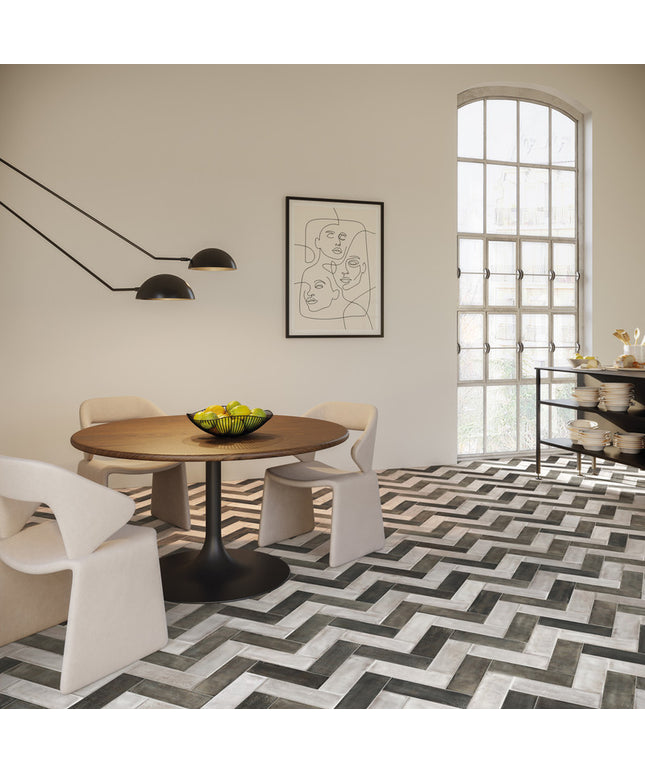 Modern dining room with a round wooden table, white chairs, and abstract art on the wall.