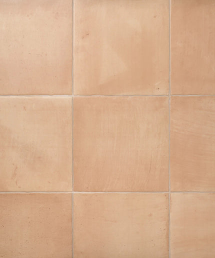 Matte tan square ceramic floor tiles with subtle texture and grout lines, ideal for kitchen or bathroom.