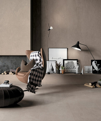 Modern living room with large format beige floor tiles, accent chair, and minimalist decor