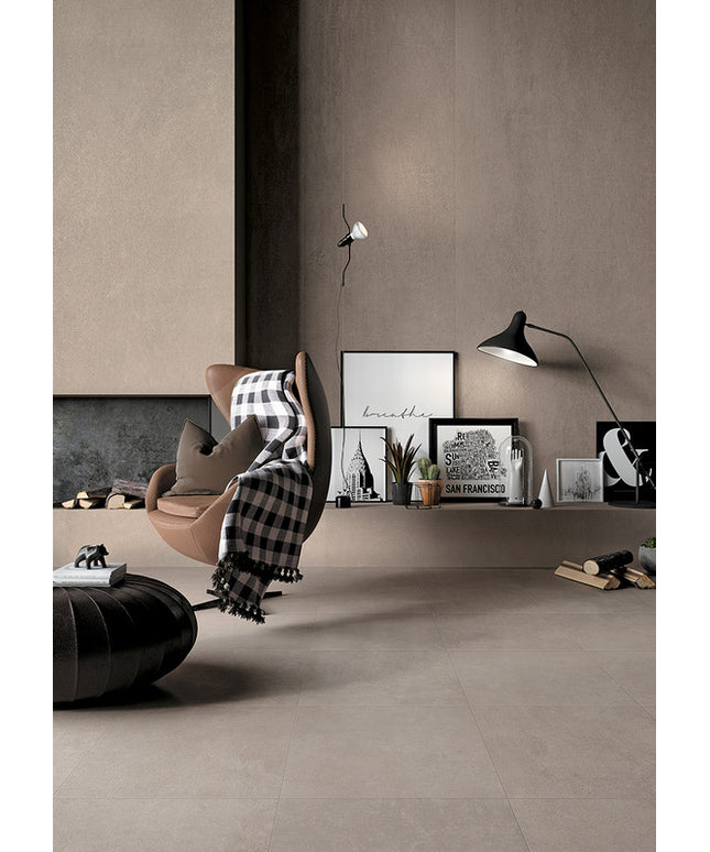 Modern living room with large format beige floor tiles, accent chair, and minimalist decor