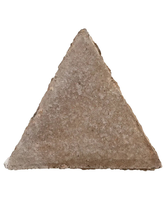 Triangular stone tool on a white background