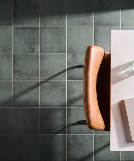 Collage of a dark green tiled wall and a kitchen counter with a wooden handle.