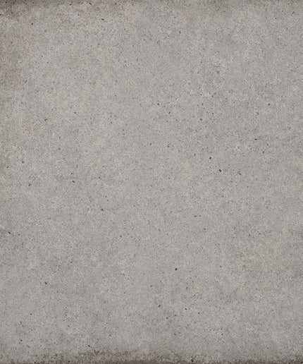 A square gray textured tile or panel with a distressed, weathered concrete-like finish and darker worn edges.
