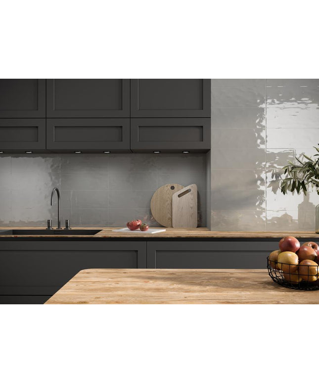 Modern kitchen with dark cabinets, wooden countertops, and a tiled backsplash.