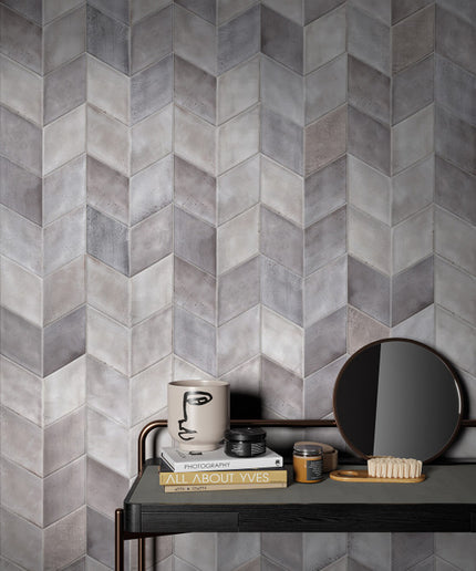 Gray tiled wall with a small table and decorative items in front