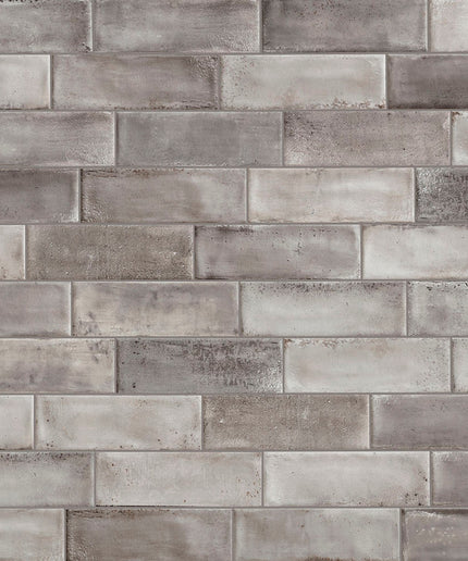 Pattern of gray bricks with varying shades on a textured background