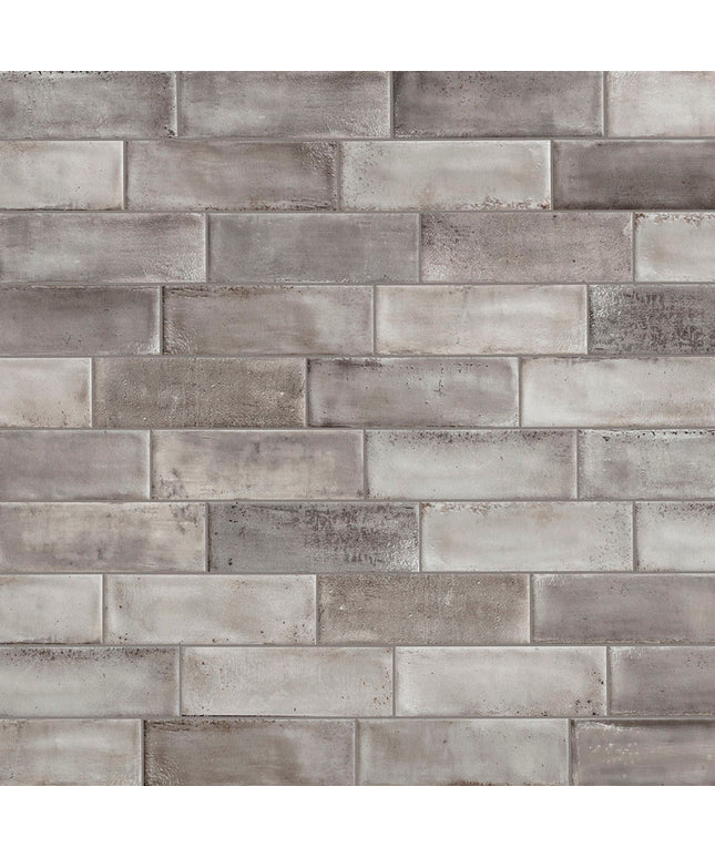 Pattern of gray bricks with varying shades on a textured background