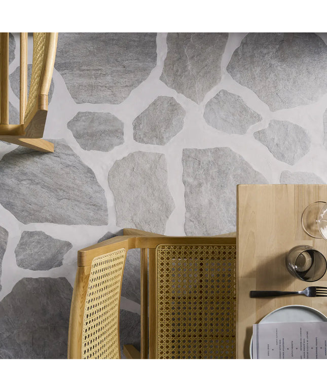Gold chair and table with stone-patterned wall in the background