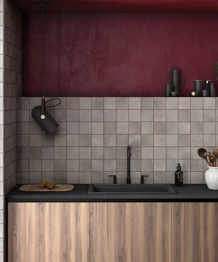 Modern kitchen with wooden cabinets, black countertop, and tiled wall.
