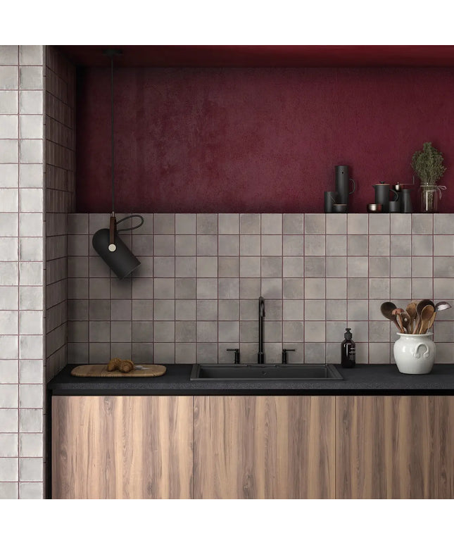 Modern kitchen with wooden cabinets, black countertop, and tiled wall.