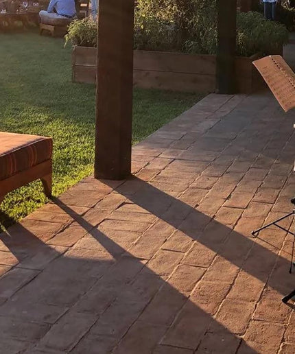 Italian terracotta floor tiles on a patio with sunlight and garden setting