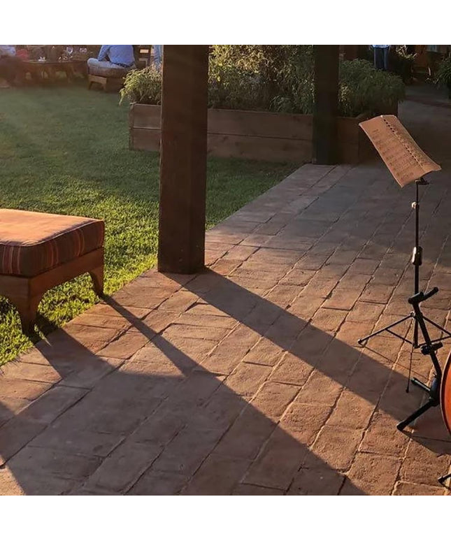 Italian terracotta floor tiles on a patio with sunlight and garden setting