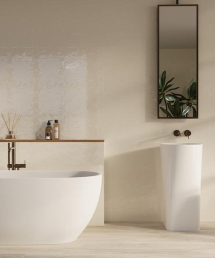 Modern bathroom with a freestanding bathtub, sink, and decorative elements.